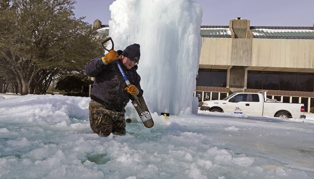 City of Richardson, TX worker Kaleb Love breaks ice on a frozen fountain. (AP Images)