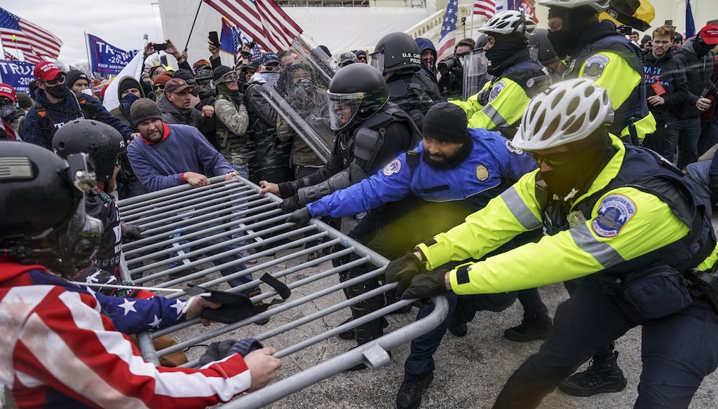 Rioters try to break through a police barrier at the Capitol in Washington on Jan. 6, 2021. (AP)