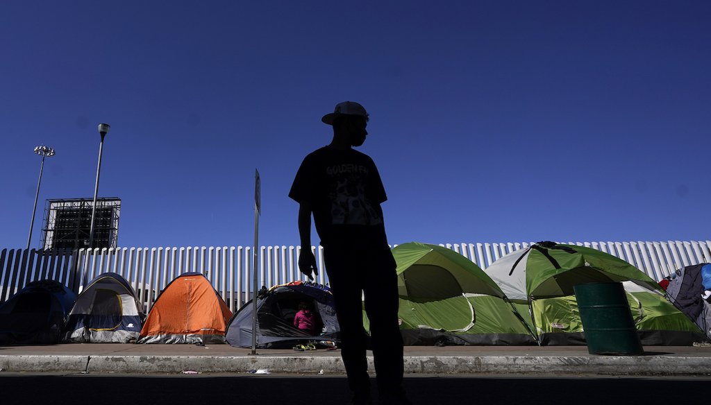 A migrant from Honduras seeking asylum in the U.S. stands in front of tents at the border crossing on March 1, 2021, in Tijuana, Mexico. (AP/Bull)