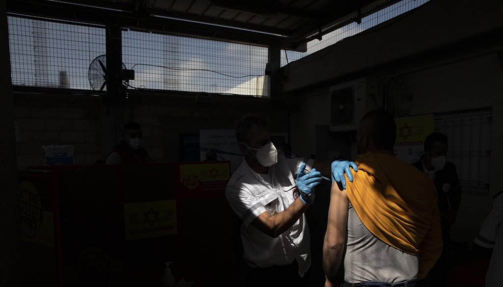 A Palestinian who works in Israel receives a Moderna COVID-19 vaccine at the Tarkumiya crossing between the West Bank and Israel, Monday, March 8, 2021. (AP)