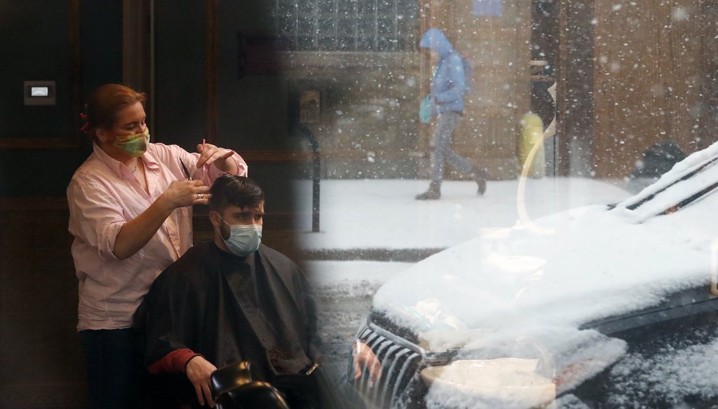 Gina Loukas, left gives a haircut to Ryan as a lone pedestrian is reflected in the barbershop window Monday, March 15, 2021, as fresh snow falls in Chicago. (AP Images)