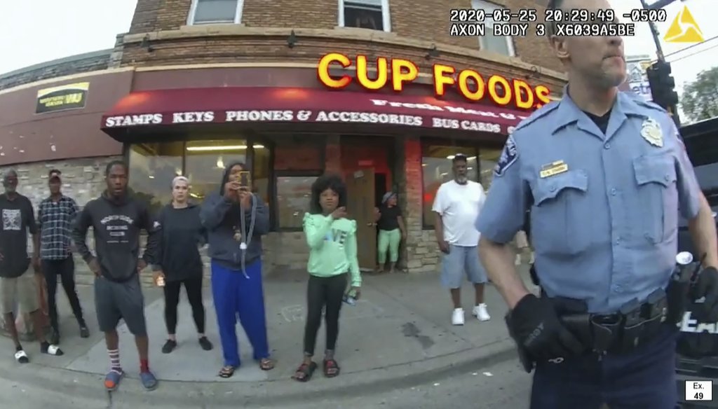 In this image, captured from police body camera video, former Minneapolis police Officer Derek Chauvin stands outside Cup Foods in Minneapolis, on May 25, 2020, with a crowd of onlookers behind him. (AP)