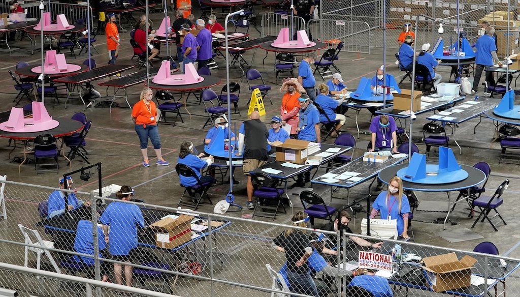 Maricopa County ballots cast in the 2020 general election are examined and recounted by contractors working for Florida-based company, Cyber Ninjas, at Veterans Memorial Coliseum in Phoenix on May 6, 2021. (AP/York)