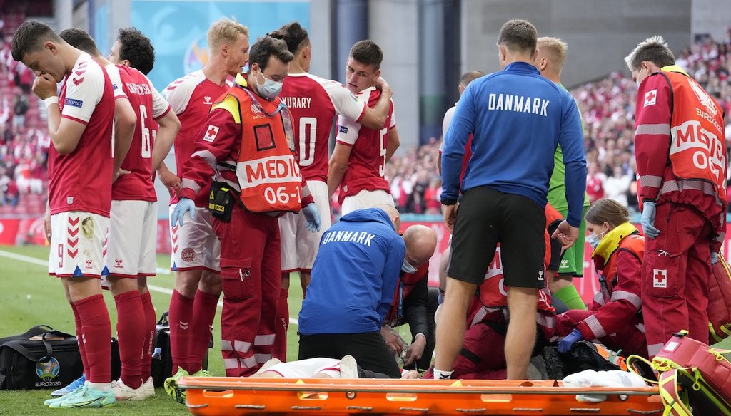 Danish soccer player Christian Eriksen getting help from medics after he collapsed on June 12, 2021. His collapse was not a result of COVID-19 vaccines. (AP)