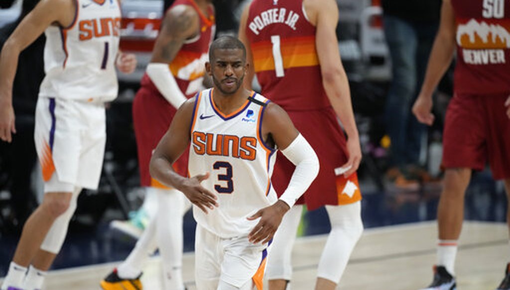 Phoenix Suns guard Chris Paul, front, in Game 4 of an NBA second-round playoff series against the Denver Nuggets on June 13, 2021. (AP)