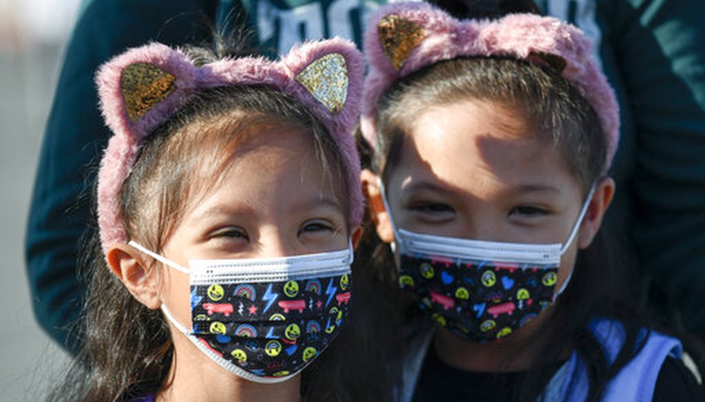 Masked students wait to go their classrooms on the first day of school at Enrique S. Camarena Elementary School Wednesday, July 21, 2021, in Chula Vista, Calif. (AP)