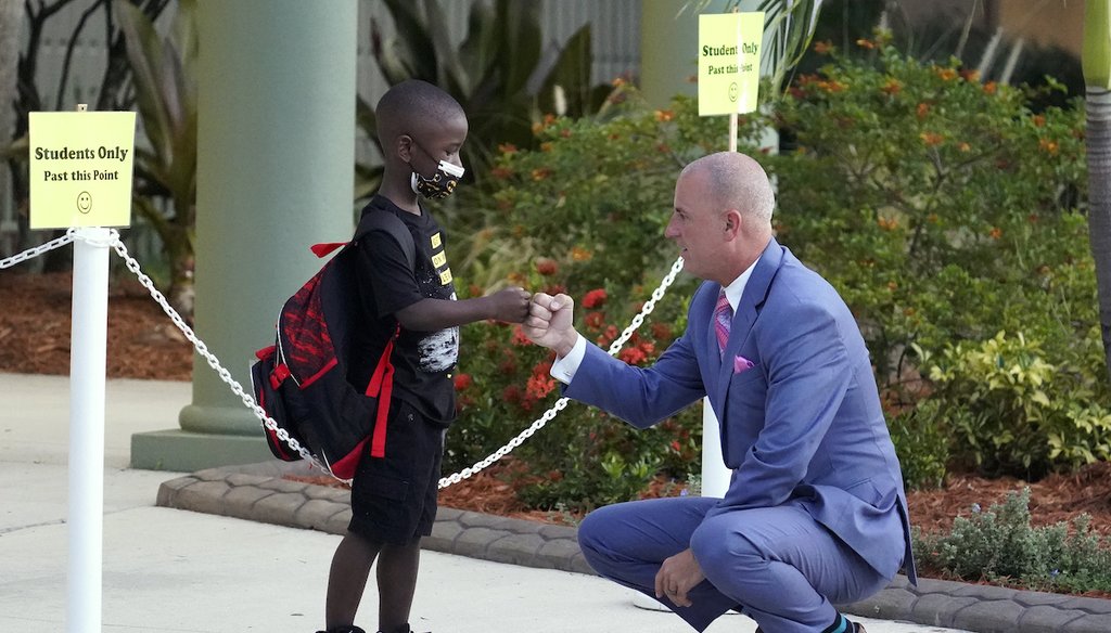 Addison Davis, Hillsborough County Superintendent of Schools, right, fist bumps student James Braden before he heads to class on the first day of school at Sessums Elementary School on Aug. 10, 2021, in Riverview, Fla. (AP)