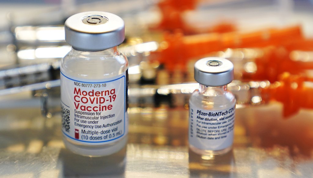 Vials for the Moderna and Pfizer-BioNTech COVID-19 vaccines are displayed at a temporary clinic outside a high school in Exeter, N.H., on Feb. 25, 2021. (AP/Krupa)