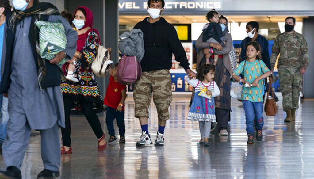 Families evacuated from Kabul, Afghanistan, walk through the terminal at Washington Dulles International Airport on Sept. 3, 2021. (AP)