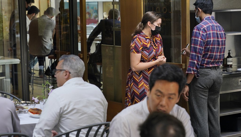 A maitre d' checks guests' proof of vaccination at a restaurant in midtown Manhattan in New York, Monday, Sept. 13, 2021. (AP)