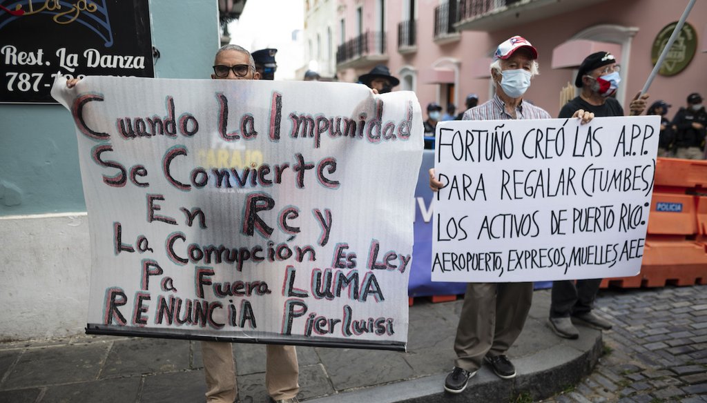 Demonstrators from various organizations congregate on Fortaleza street to protest against the constant selective blackouts that the island has suffered for weeks due to low power generation, in San Juan, Puerto Rico, Oct. 1, 2021. (AP)