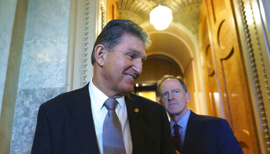 Sen. Joe Manchin, D-W.V., greeted by Sen. Pat Toomey, R-Pa., right, leaves the chamber after a vote, at the Capitol in Washington. (2021 | AP)