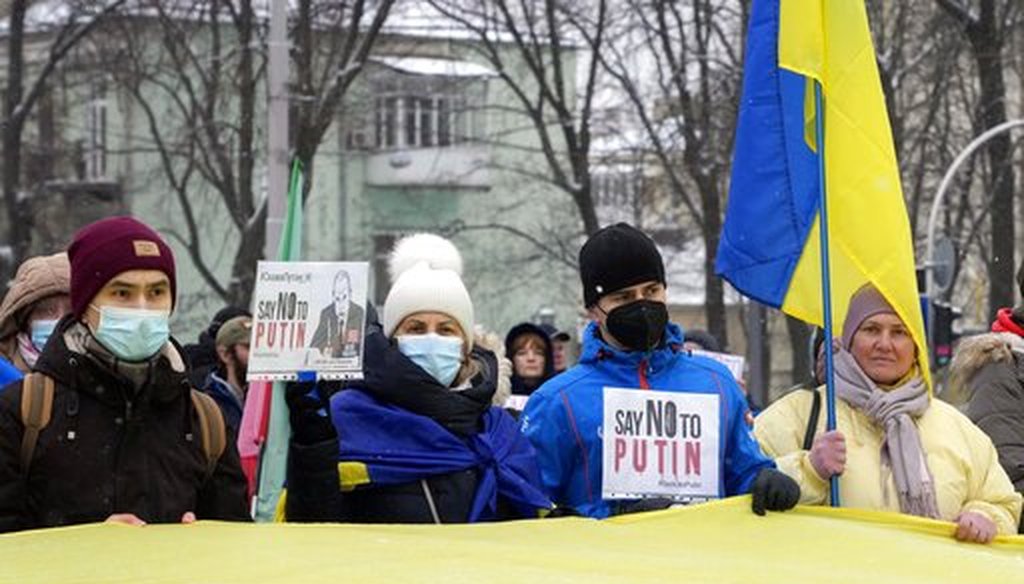 Activists hold posters and national flags during rally opposing Russian president Vladimir Putin in Kyiv, Ukraine, on Jan. 9, 2022. (AP)