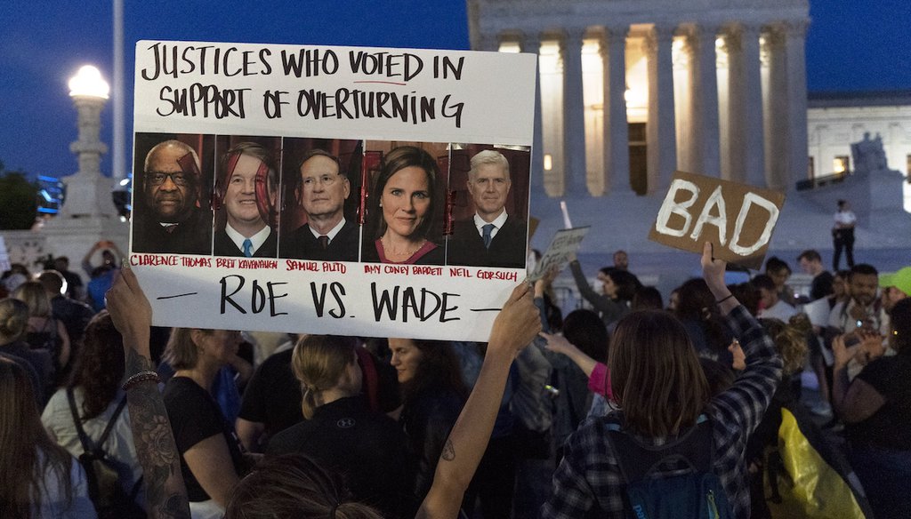 A sign with pictures of Supreme Court Justices Thomas, Kavanaugh, Samuel Alito, Amy Coney Barrett, and Neil Gorsuch is held by demonstrators outside of the U.S. Supreme Court, on May 3, 2022, in Washington. (AP)