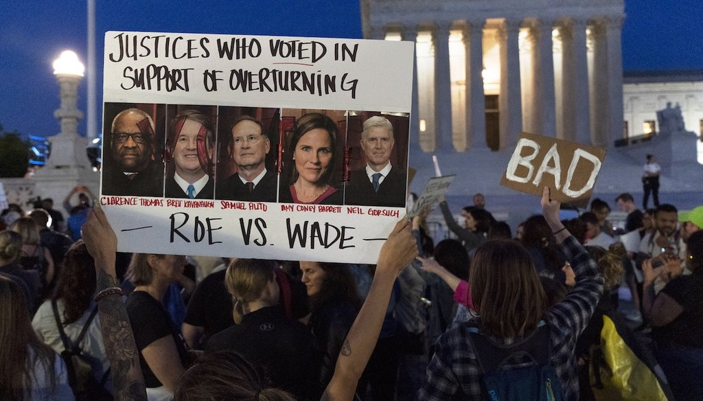 A sign with pictures of Supreme Court Justices Thomas, Kavanaugh, Samuel Alito, Amy Coney Barrett, and Neil Gorsuch is held by demonstrators outside of the U.S. Supreme Court, on May 3, 2022, in Washington. (AP)