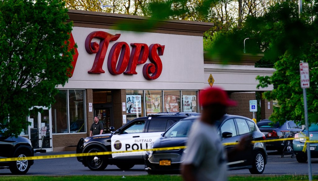 A person walks past the scene of a shooting at a supermarket, in Buffalo, N.Y., on May 15, 2022. (AP)