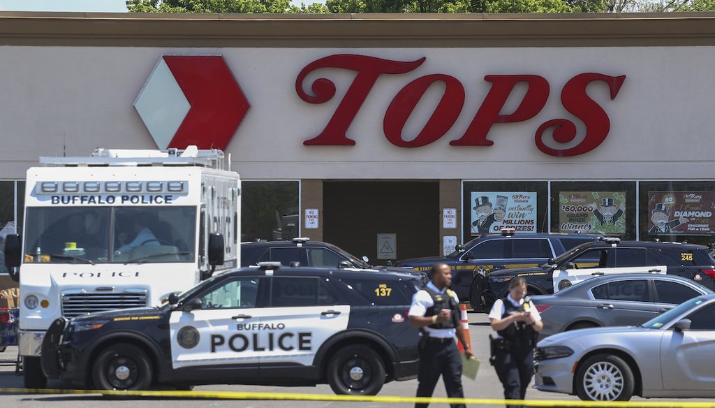 Police walk outside the Tops grocery store on May 15, 2022, in Buffalo, N.Y. (AP)