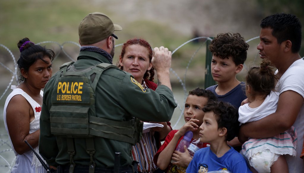 A Border Patrol officer talks to migrants after they crossed the Rio Grande river in Eagle Pass, Texas, Sunday May 22, 2022. (AP)