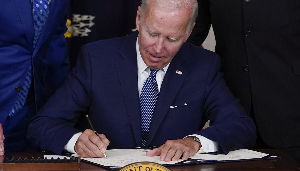 President Joe Biden signs the Democrats' landmark climate change and health care bill at the White House on Aug. 16, 2022. (AP)