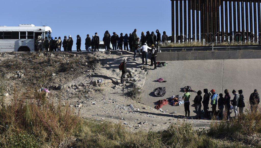 Migrants wait to get into a U.S. government bus after crossing the border from Ciudad Juarez, Mexico, to El Paso, Dec. 12, 2022. (AP)