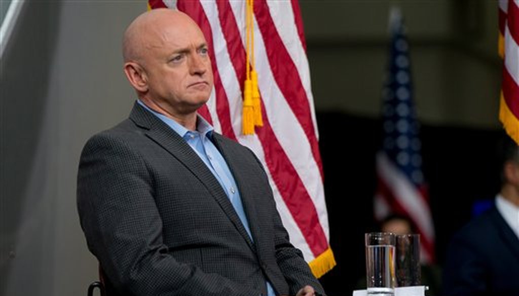 Astronaut Mark Kelly sits on stage as Democratic presidential candidate Hillary Clinton holds a rally at Iowa State University in Ames, Iowa, Jan. 30, 2016. (AP/Andrew Harnik)