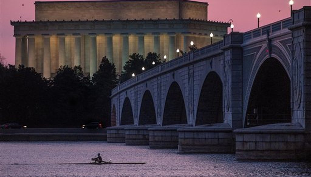 A rower moves along the Potomac River near the Lincoln Memorial in Washington, D.C., on March 21, 2014. (AP/Ake)