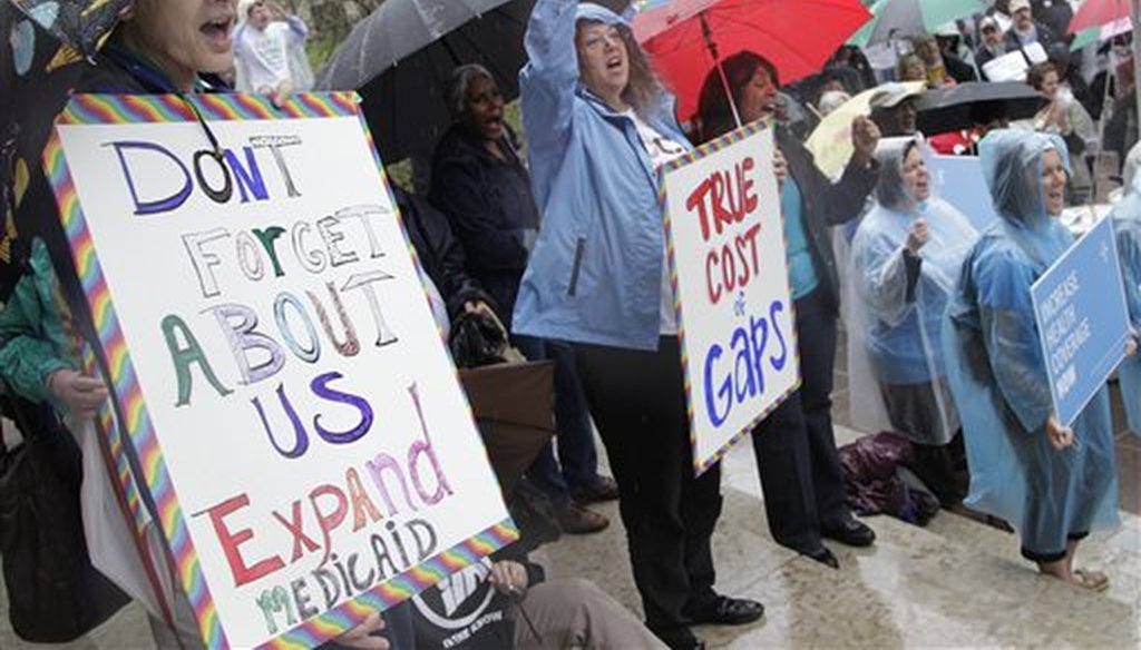 Demonstrators support for Medicaid extension outside the Ohio Statehouse during a rally on Thursday, April 11, 2013, in Columbus, Ohio. (AP/Jay LaPrete)