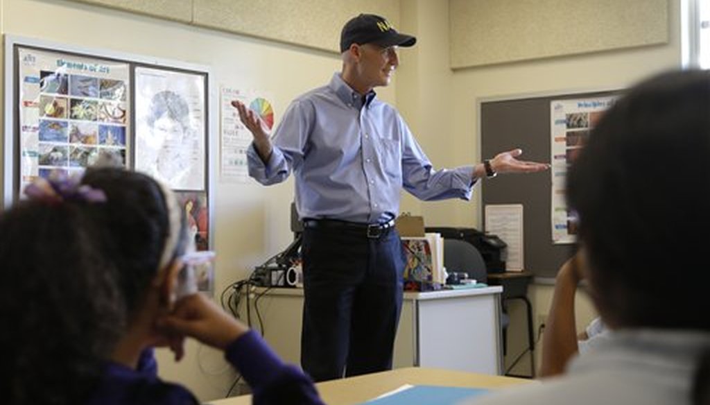Republican Florida Gov. Rick Scott talks with students before holding a news conference with Alberto Carvalho, superintendent of Miami-Dade County Public Schools, at Southside Elementary School, Wednesday, Aug. 27, 2014, in Miami. (AP)