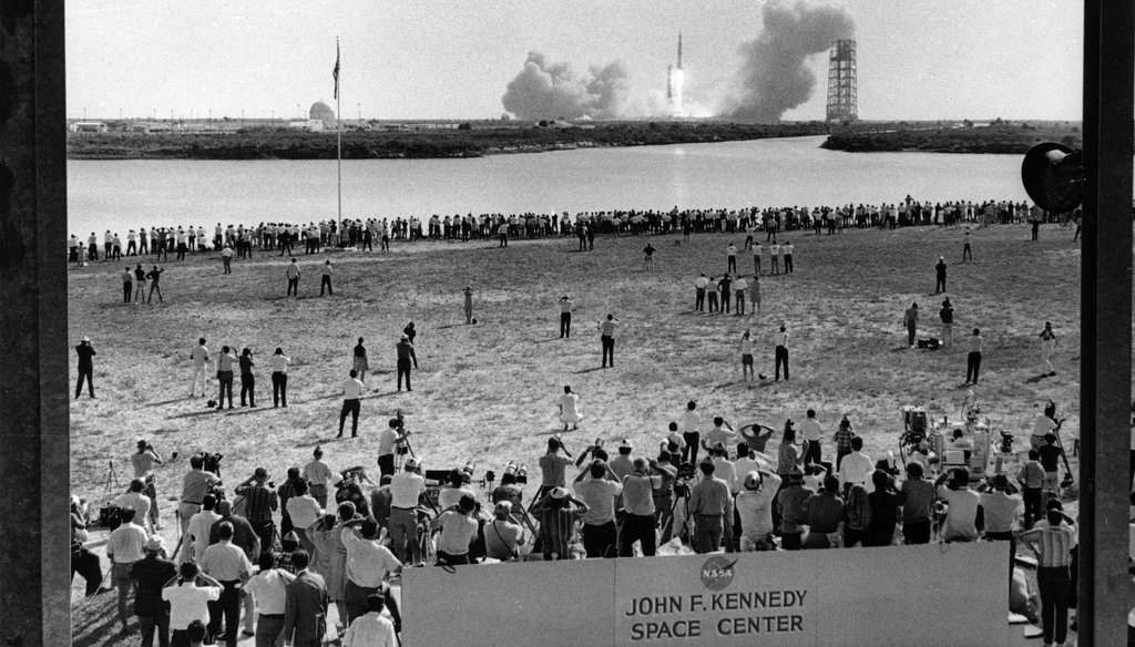 Thousands of newsmen and photographers line the banks of a lagoon at the Cape Kennedy Press Site on July 16, 1969 as the Saturn 5 Rocket with Apollo 11 astronauts aboard thunders from its launch pad three and a half miles away.