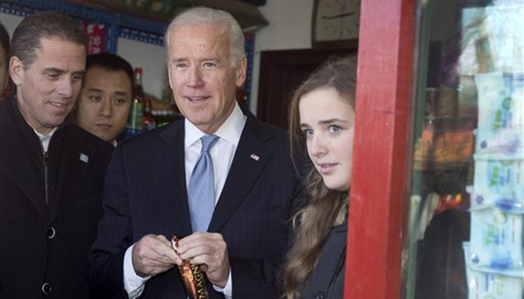 Then-Vice President Joe Biden buys an ice-cream at a shop in Beijing with his granddaughter Finnegan Biden, right, and son Hunter Biden, left, on Dec. 5, 2013. (AP)