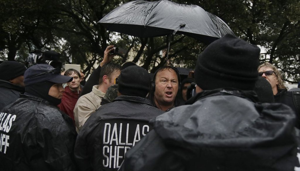Infowars' Alex Jones leads a protest after a ceremony to mark the 50th anniversary of the assassination of John F. Kennedy in Dallas on Nov. 22, 2013.