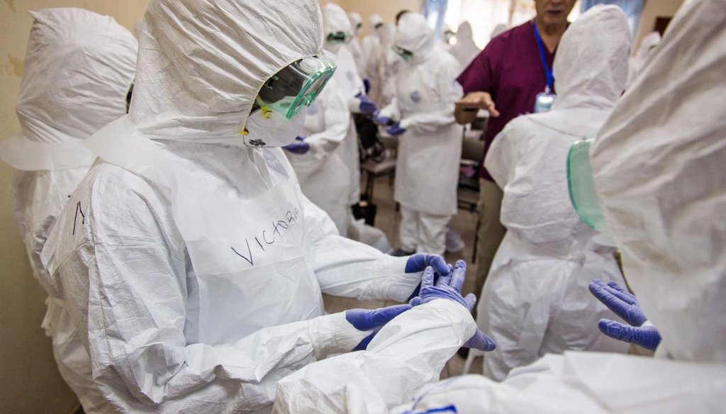A World Health Organization worker, right rear, trains nurses to use Ebola protective gear in Freetown, Sierra Leone, Sept. 18, 2014. (AP)