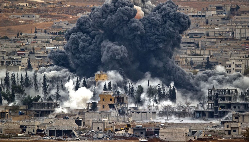 Smoke rises from the Syrian city of Kobani, following an airstrike by the U.S.-led coalition, seen from a hilltop outside Suruc, on the Turkey-Syria border on Nov. 17, 2014.