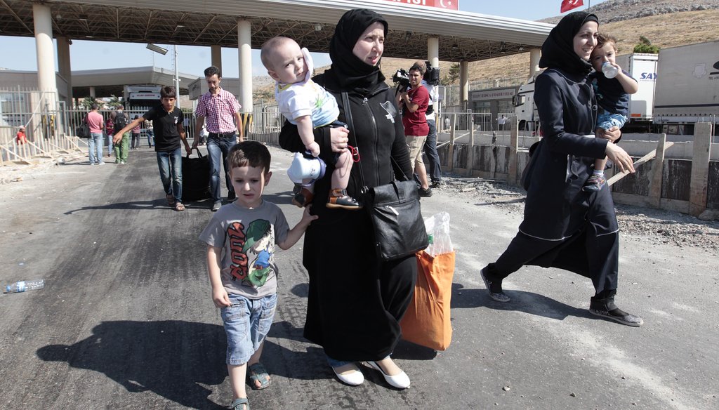 Syrian refugees pass through the Turkish Cilvegozu gate border on Aug. 31. (Associated Press)