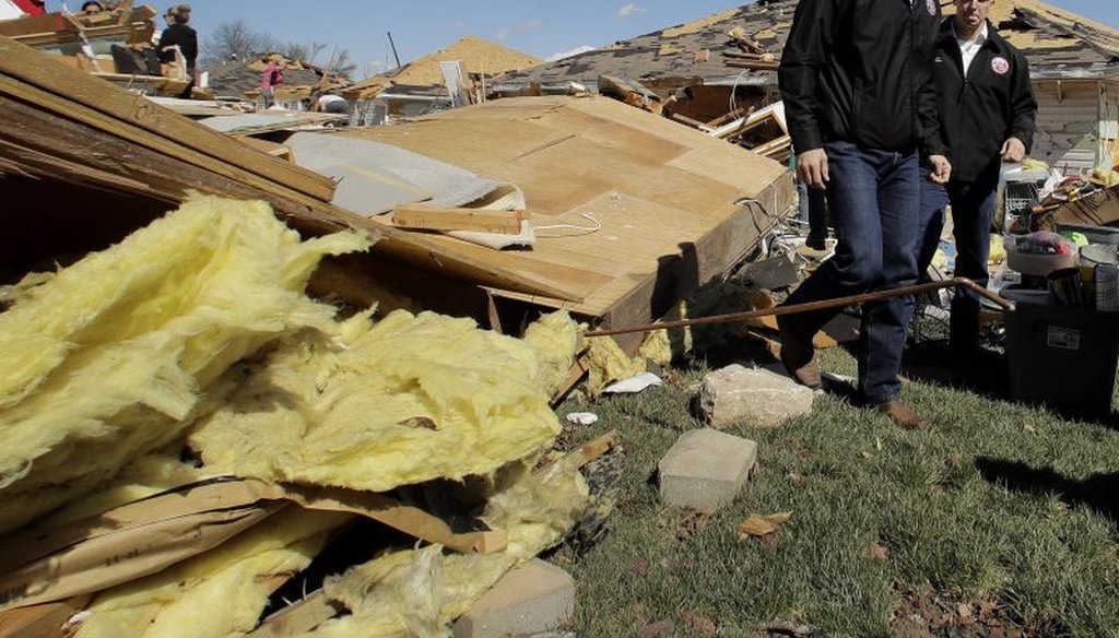Missouri Gov. Eric Greitens surveys damage to homes that were destroyed by a tornado Tuesday, March 7, 2017, after a severe storm passed through Oak Grove, Mo.