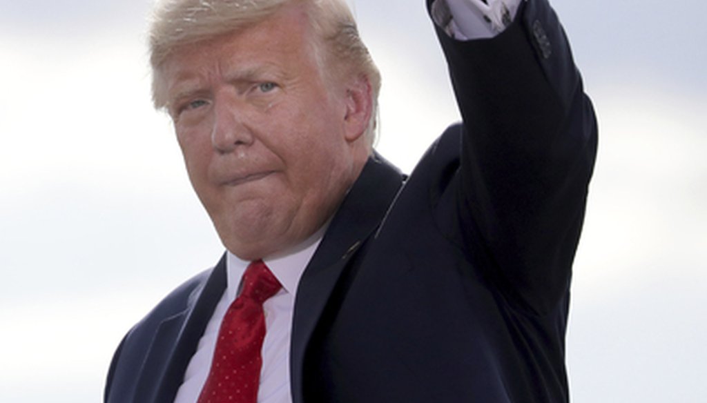 President Donald Trump waves as he leaves following a visit to Basler Flight Service on Monday, Aug. 17, 2020, at Wittman Regional Airport in Oshkosh, Wis. (Wm. Glasheen/The Post-Crescent via AP)