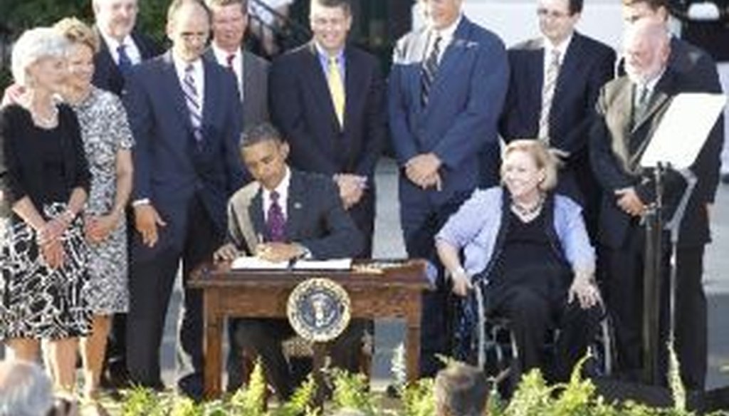 President Barack Obama signs an executive order to increase federal employment of people with disabilities on the 20th anniversary of the Americans with Disabilites Act on July 26, 2010. 