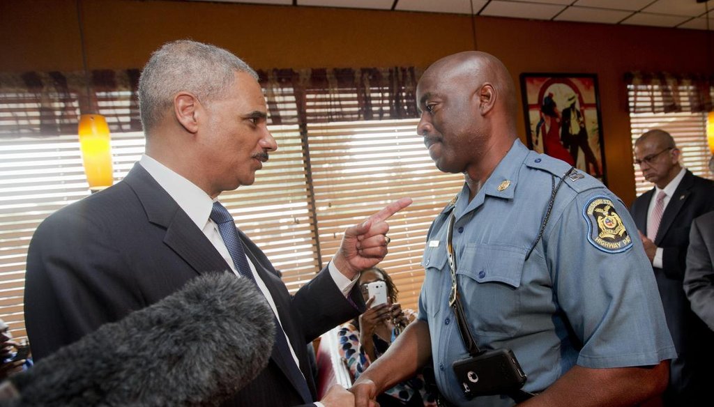 Attorney General Eric Holder talking with Capt. Ron Johnson of the Missouri State Highway Patrol at Drake's Place Restaurant in Florrissant, Mo. (AP)
