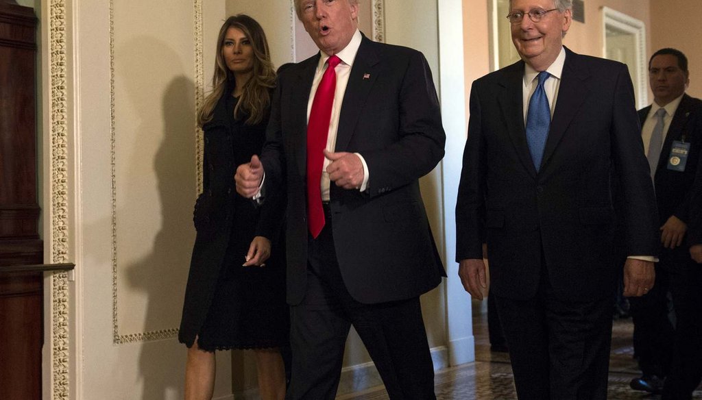 In this Nov. 10, 2016, photo, President-elect Donald Trump, accompanied by his wife Melania, and Senate Majority Leader Mitch McConnell of Ky., gestures while walking on Capitol Hill in Washington. (AP Photo/Molly Riley)