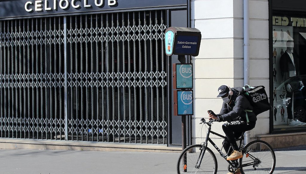 A man of a food delivery service rides his bike in Paris, Thursday, March 19, 2020. (Associated Press)