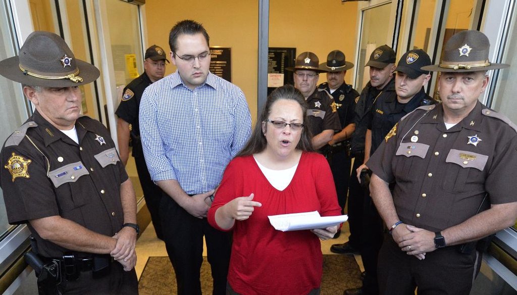 Rowan County Clerk Kim Davis returned to work Sept. 14, 2015, surrounded by sheriff's deputies and her son, Nathan Davis, after a judge ordered her to jail for refusing to issue marriage licenses to same-sex couples. (AP)
