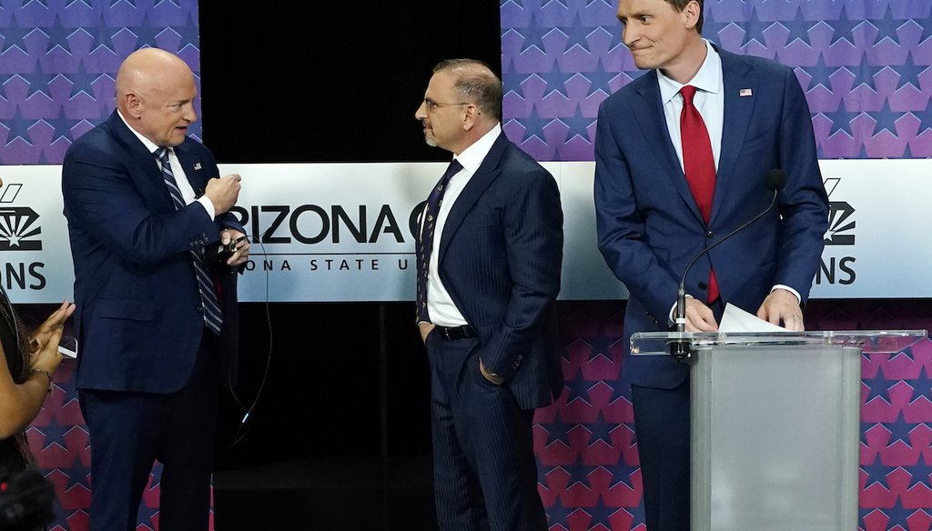 Arizona Democratic Sen. Mark Kelly, left, talks with Libertarian candidate Marc Victor, middle, and Republican candidate Blake Masters, right, before a televised debate in Phoenix, Oct. 6, 2022. (AP)