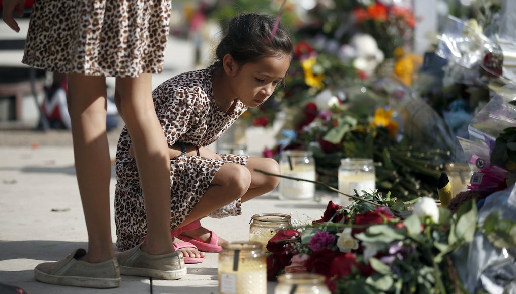 On May 27, 2022, a child looks at a memorial site for the victims killed in the May 24 shooting at Robb Elementary School in Uvalde, Texas. (AP)