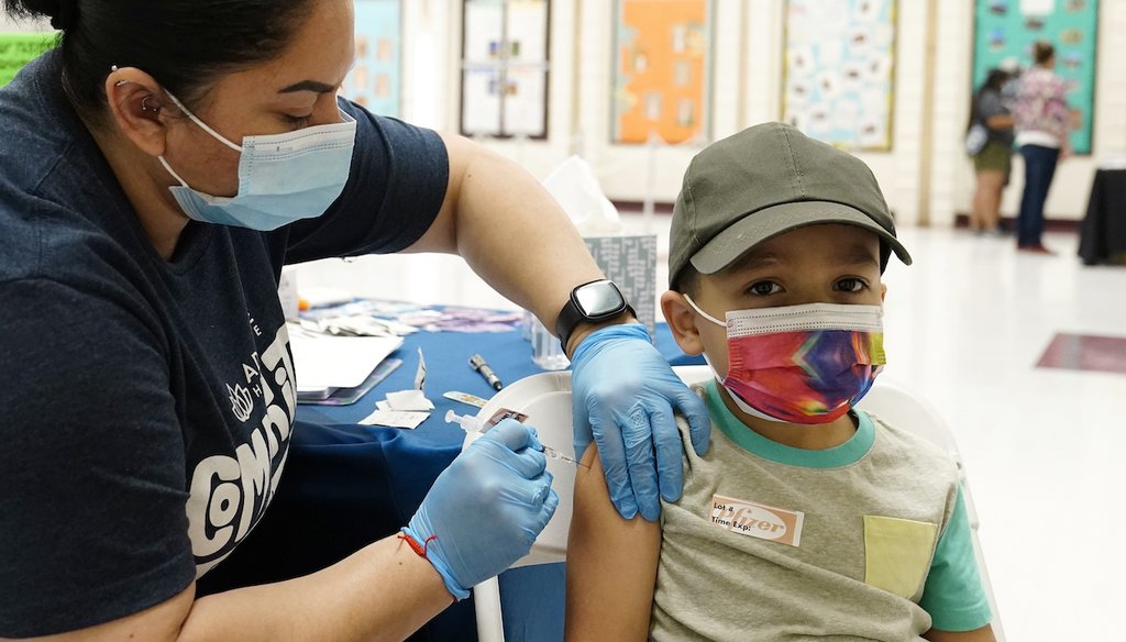 A nurse gives a child, aged 5, the first dose of the Pfizer vaccine on Nov. 6, 2021. This was the first time children aged 5 to 11 across the United States had the opportunity to get immunized against COVID-19. (AP Photo)