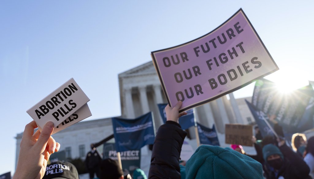 Abortion rights advocates showing a pack of abortion pills demonstrate in front of the U.S. Supreme Court on Dec. 1, 2021, as the court hears arguments in a case from Mississippi, where a 2018 law would ban abortions after 15 weeks. (AP)