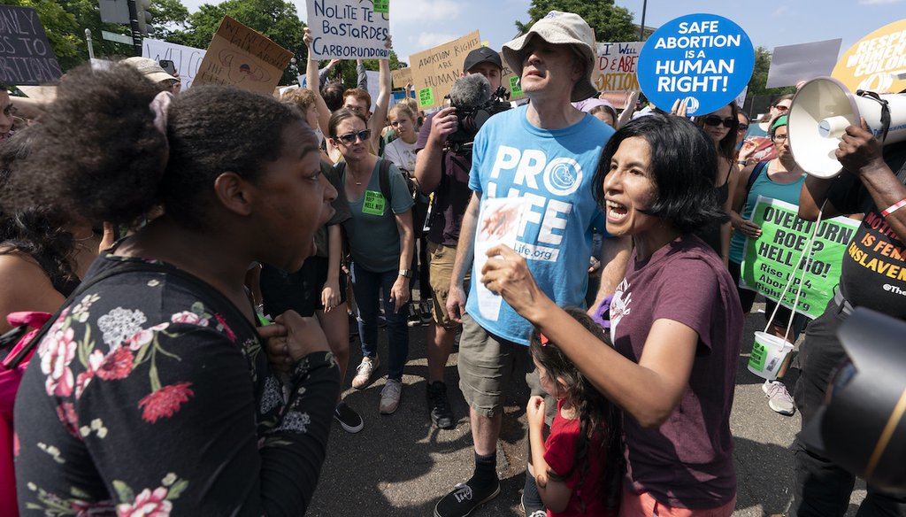 Anti-abortion demonstrators and abortion rights demonstrators argue outside the Supreme Court in Washington, Friday, June 24, 2022. (AP)