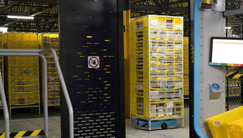 A stack of product-loaded tubs is moved into a stow and picking kiosk at the Amazon Robotic Sorting Fulfillment Center in Madison County, Mississippi, Aug. 11, 2022 (AP)