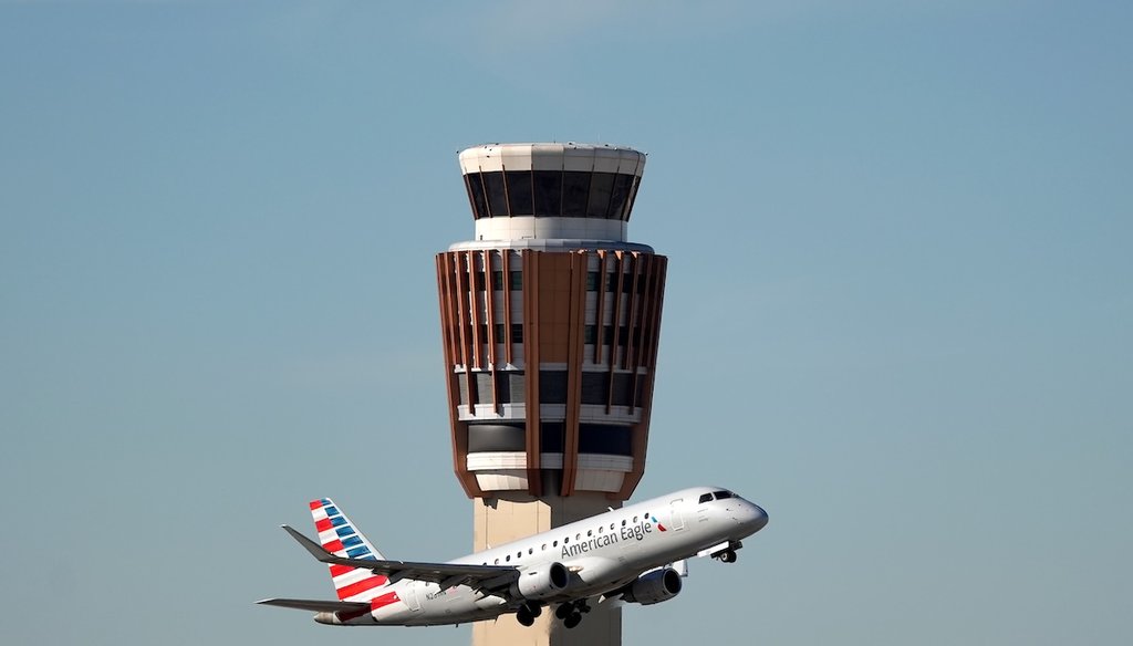 An American Airlines American Eagle jet flies past the air traffic control tower at Phoenix Sky Harbor International Airport, Nov. 8, 2025, in Phoenix. (AP)