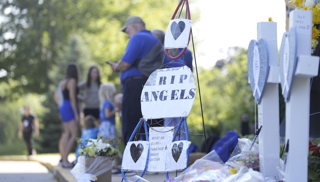 People stand by a makeshift memorial at Annunciation Catholic Church after Wednesday's school shooting, Aug. 28, 2025, in Minneapolis. (AP)