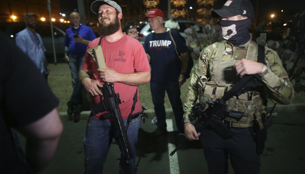 Armed supporters of President Donald Trump stand outside of Maricopa County Recorder's Office where votes in the general election are being counted, in Phoenix on Thursday, Nov. 5, 2020. (AP)